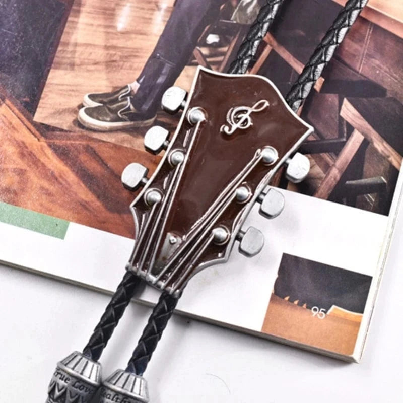 Bolo tie med gitarrhuvud i metall och läderrem